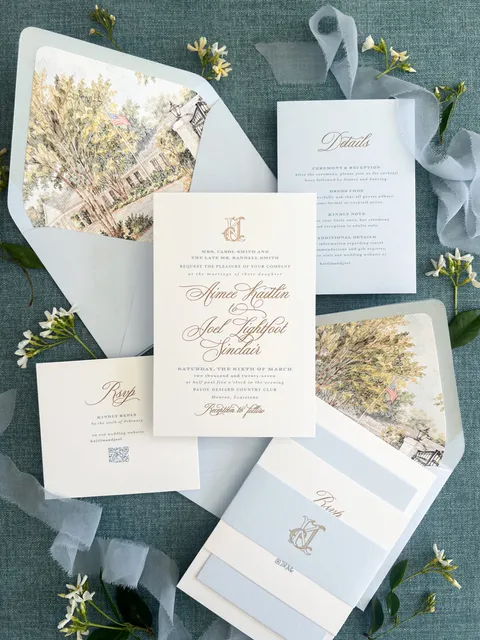 Wedding invitation suite by Kattone Paper featuring Mozart Script calligraphy by Blessed Print, illustrated venue envelope liners and pale blue ribbon.