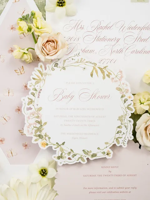 Botanical baby shower invitation with a scalloped floral border and pale pink Juliette calligraphy by Rachel Wiedenfeld Studio. Styling and photograph by Annie Lui Photography Flatlays.