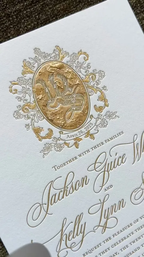 Video cover of a letterpress wedding invitation with Mozart Script calligraphy by Blessed Print and hand-painted gold-leaf detailing by Kristy Rice of Momental.