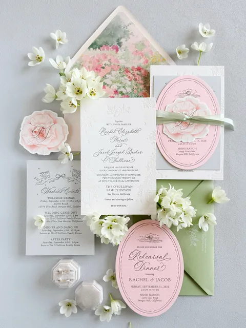 Pink and green wedding invitation suite by Ashley Bunten Design featuring La Rumba calligraphy, hand-drawn details and floral envelope liners.