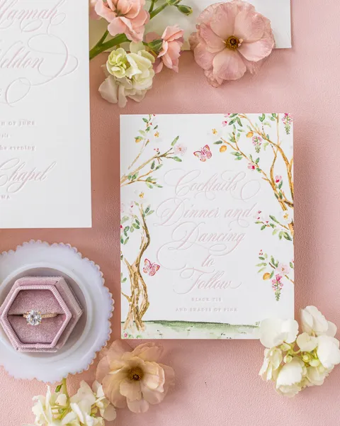 Floral reception card by Empress Stationery featuring pink Juliette calligraphy, a garden border and coordinating pink wax seals.