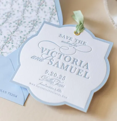 Blue letterpress save-the-date card on cotton paper by Magnolia Boone Paperie featuring Mozart Script calligraphy by Blessed Print. Photograph by Jessica Bordner.