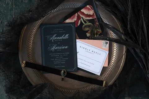 Black wedding invitation with Mozart Script calligraphy by Blessed Print and a velvet floral envelope liner by Reverie Paper Co. Photograph by Margaret McCanna.