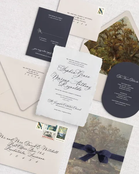 Sophia wedding invitation suite by Ashley Barado of InvitoBella featuring La Rumba calligraphy, botanical envelope liners and navy blue coordinating cards.
