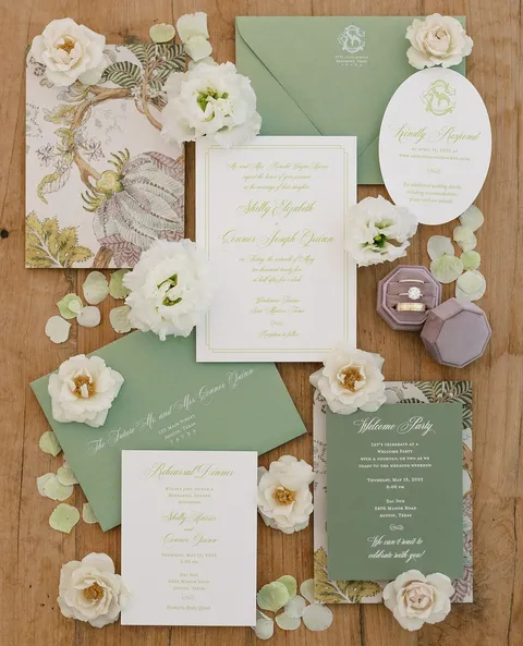 Floral wedding stationery by The Inviting Pear featuring Mozart Script, green envelopes and illustrated liners. Photograph by Ruet Photo, shared by Stradley Davidson.
