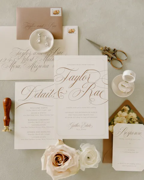 Neutral wedding stationery by Ashley Bunten Design with Mozart Script calligraphy, wax seals and a cream rose. Photograph by Taryn Becchina.