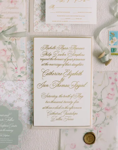 Garden wedding invitation by Magnolia Boone Paperie featuring gold Juliette calligraphy, a gold edge and pink floral coordinating stationery. Photograph by Stephanie Brazzle.