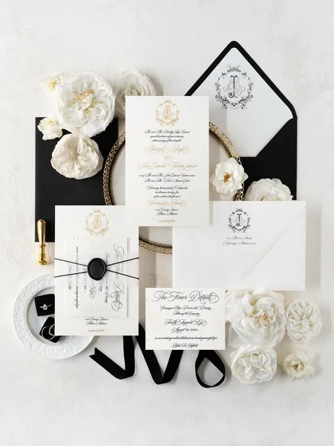 Black, white and gold wedding invitation suite by Ledgewood Fine Stationery with Juliette calligraphy, monograms and wax seals. Styling and photograph by Peterson Design & Photo.