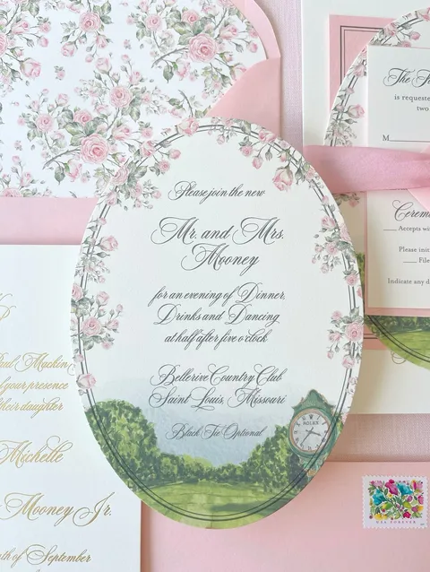Floral wedding reception card by Alicia Lantzy featuring gold Juliette calligraphy, an oval border and coordinating pink stationery.