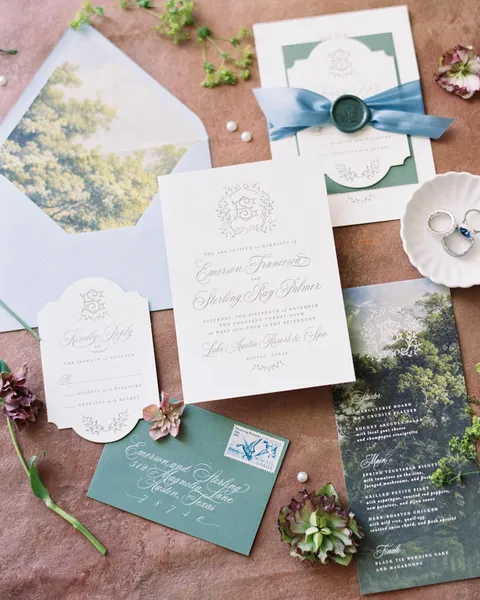 Floral wedding stationery by Cojo Moxon Design featuring Juliette calligraphy, shaped cards, teal ribbon and a wax seal. Film photograph by Shelby Day Photography.